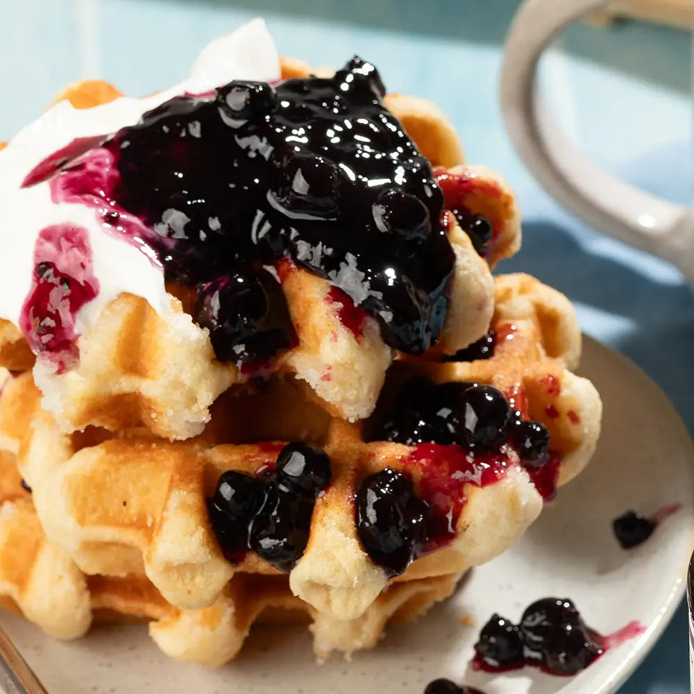 Stack of waffles with jam on a plate