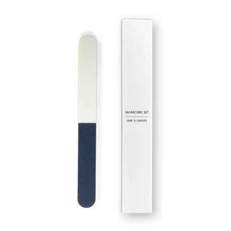 Manicure set with a white and blue nail file and a white box labelled manicure set on a white background