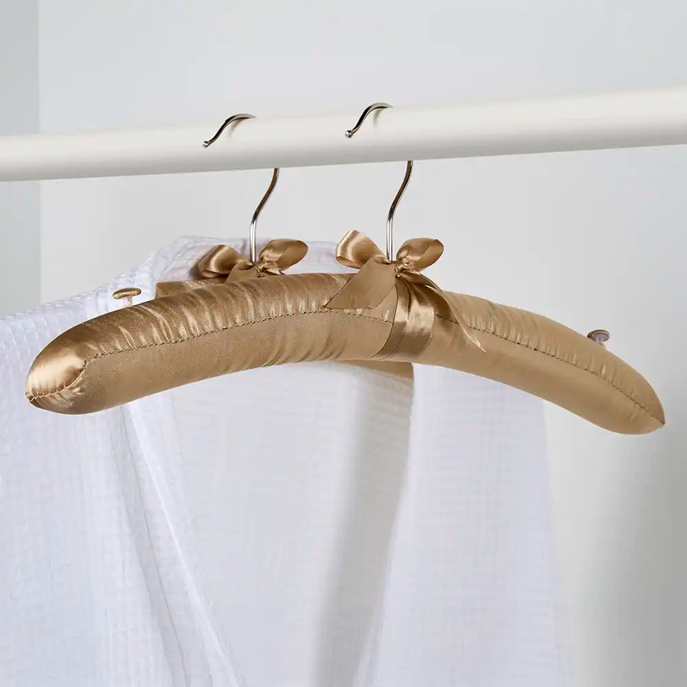 Gold satin hanger on a white background