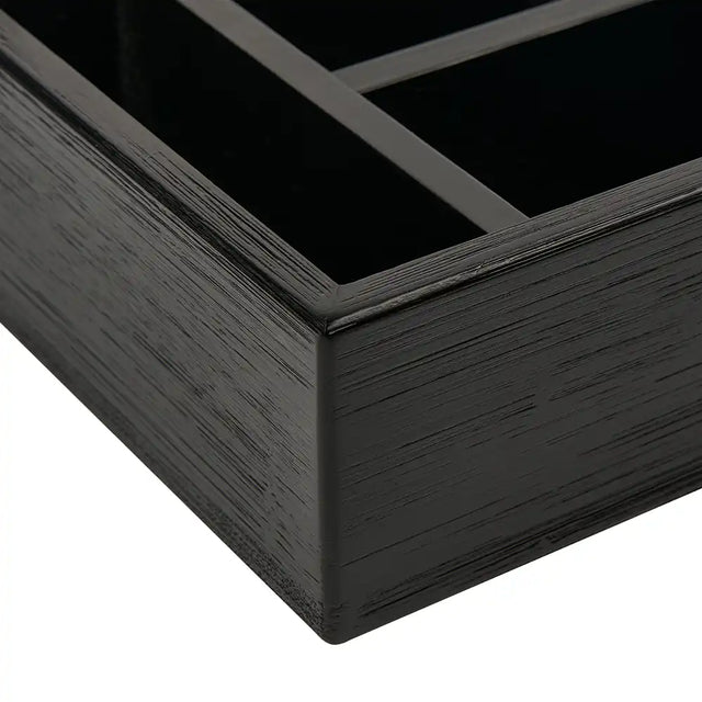 Close-up of a black wooden holder corner on a white background