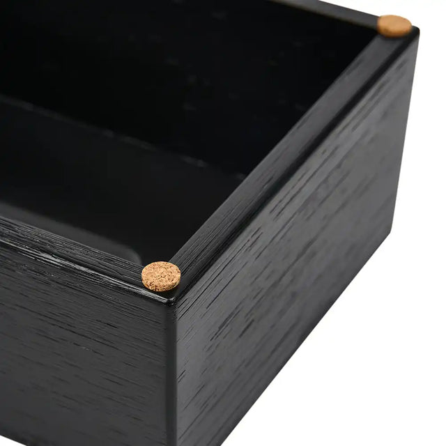 Black wooden box with cork details on a white background