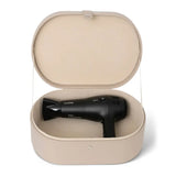 Black hair dryer in a beige storage case on a white background