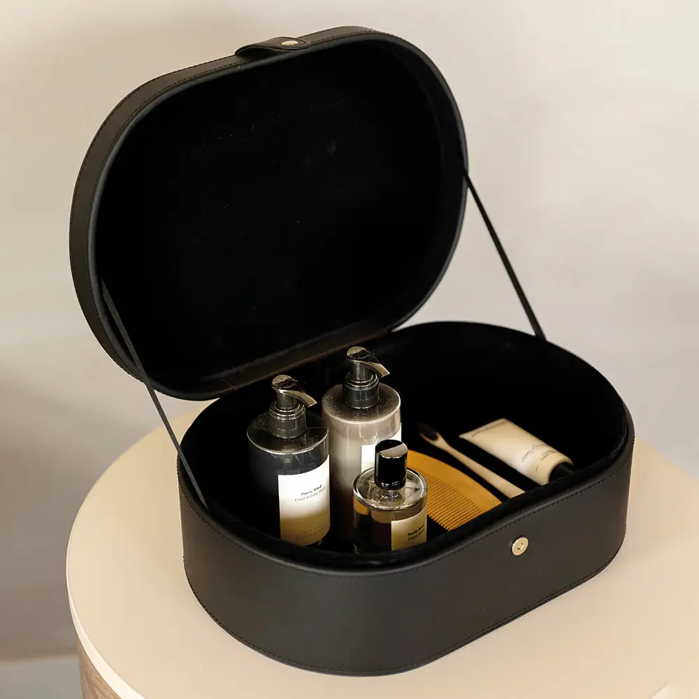 Black storage case with toiletries on a light background