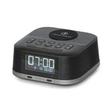 Black digital clock with wireless charging pad on a white background