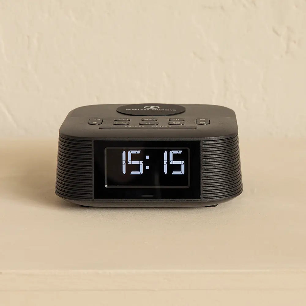 Black digital clock on a beige background