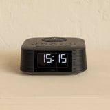 Black digital clock on a beige background