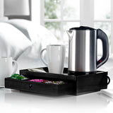 Acacia wooden hotel welcome tray with drawer, kettle, mugs and tea sachets on a bedroom table