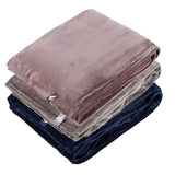 Stack of folded blankets in pink and blue on a white background