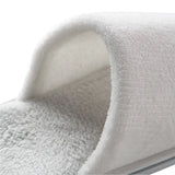 Close-up of a pair of white slippers with a soft texture on a white background