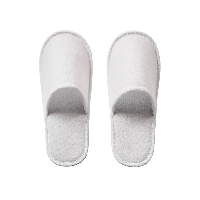 Pair of white slippers on a white background