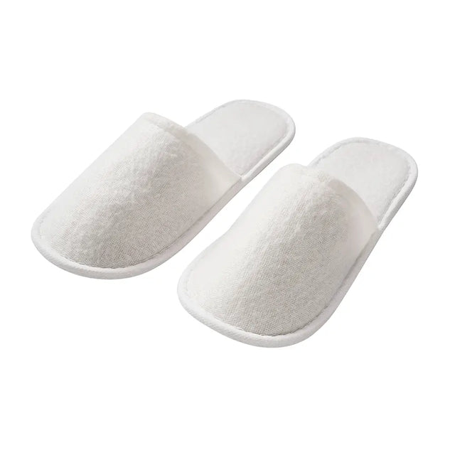 Pair of white slippers on a white background