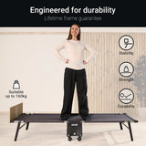 Person standing on a portable bed with durability features highlighted