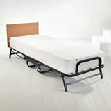 Bed with white mattress on a white floor and wall