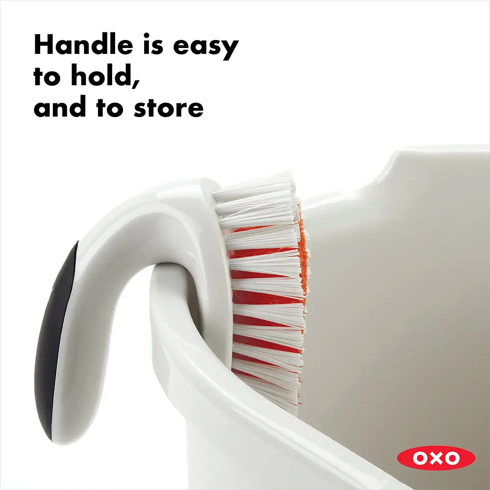 OXO cleaning brush with text 'Handle is easy to hold, and to store' on a white background