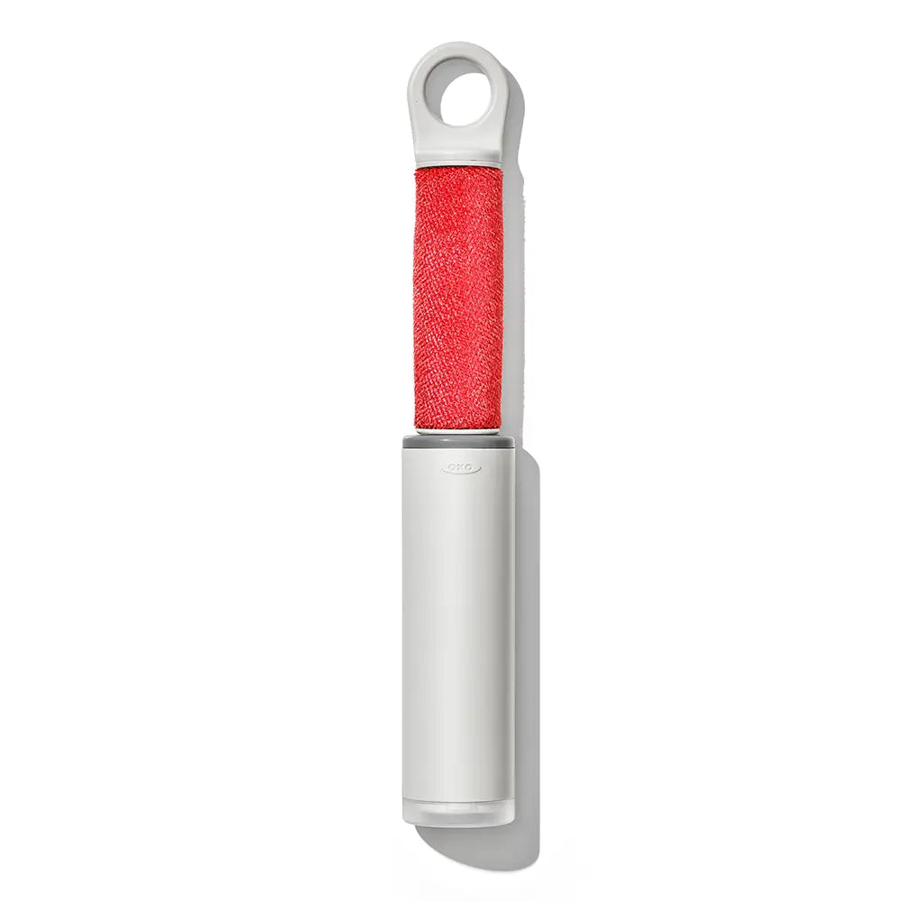 White lint remover with red roller on a white background
