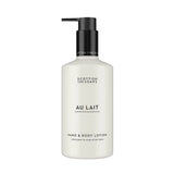 A bottle of Scottish Fine Soaps 'Au Lait' hand and body lotion, featuring a matte white bottle and a black pump dispenser, set against a plain white background.
