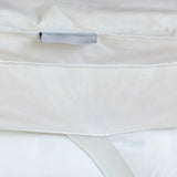Close-up of Out of Eden Luxury Down Dual Layer Mattress Topper showing box-stitch channels, fabric loop and elasticated strap