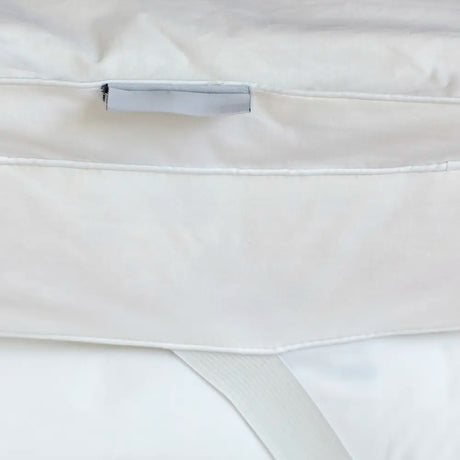 Close-up of Out of Eden Luxury Down Dual Layer Mattress Topper showing box-stitch channels, fabric loop and elasticated strap