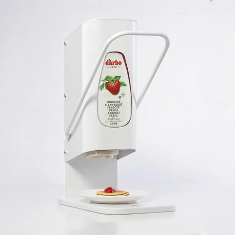 Darbo jam dispenser with lever, shown dispensing onto a pancake