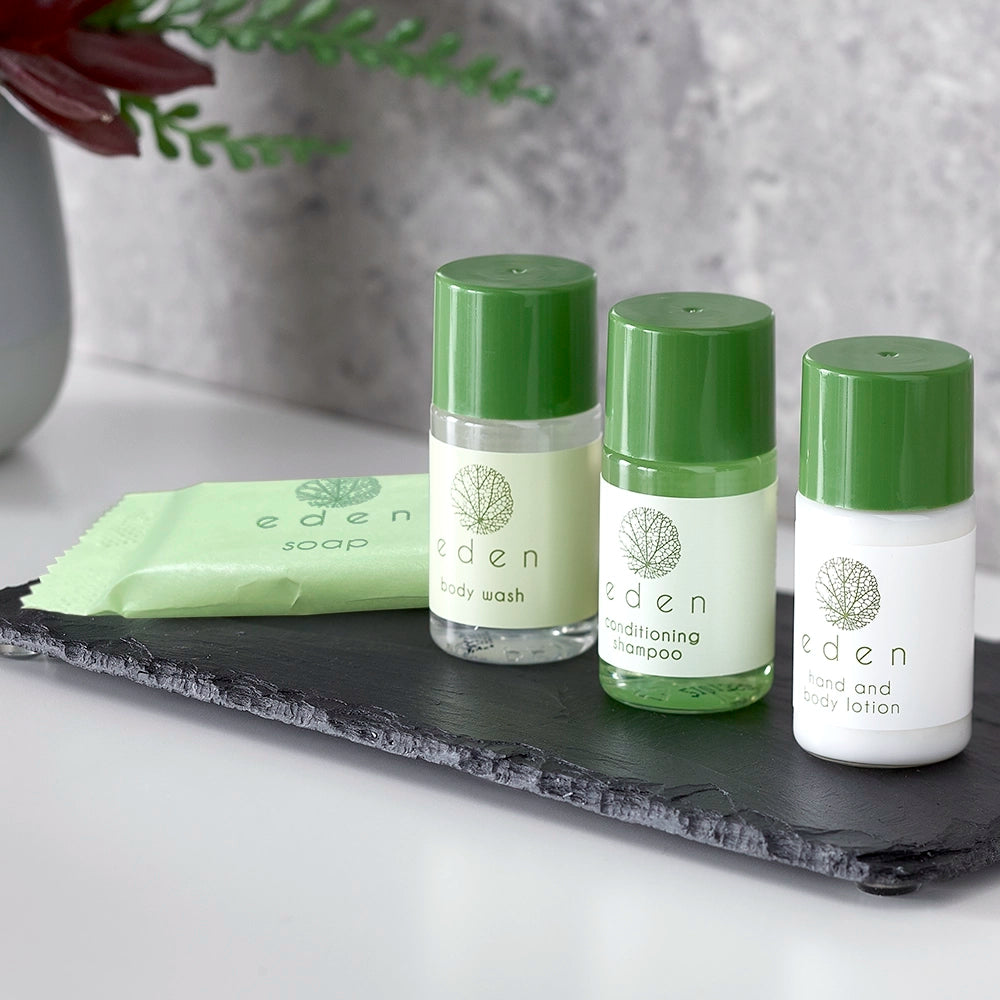 Set of Eden skincare products including body wash, shampoo, and lotion on a slate tray.