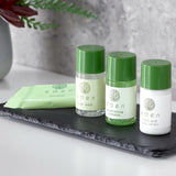 Set of Eden skincare products including body wash, shampoo, and lotion on a slate tray.