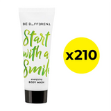 Body wash tube with green text and a yellow circle with 'x210' on a white background