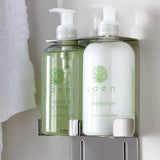 Two bottles of Eden green tea and lemon zest shampoo and conditioner on a bathroom shelf.