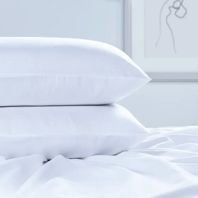 Luxury Egyptian Cotton 300 Thread Count Housewife Pillowcase on a bed in a bedroom setting