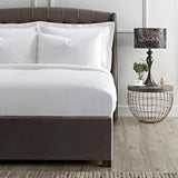 Bedroom with a beLuxury Cotton Micro Stripe 300 Thread Count Duvet Cover and a side table with a lamp.