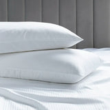 Luxury Cotton Micro Stripe 300 Thread Count Housewife Pillowcases on a bed with a grey headboard