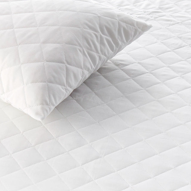 Close up of quilted pillow protector showing detailed diamond stitching
