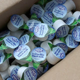 An open box of Millac Maid Milk Pots with Blue Lids