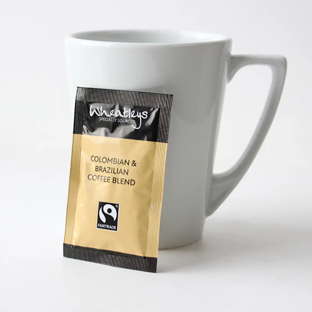 Wheatleys coffee blend package next to a white mug on a light background