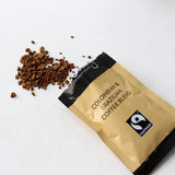 Coffee package with 'Colombian & Brazilian Coffee Blend' text and Fairtrade logo on a white background
