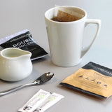 Wheatears coffee bag in a mug with biscuit milk sugar 