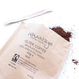 Wheatleys filter coffee package with coffee grounds on a white background