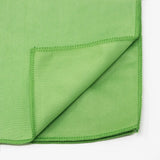 Green fabric with a folded corner on a white background