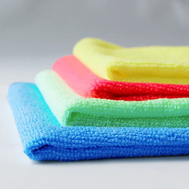Red, yellow, green and blue  commercial-grade cloth in a folded pile showing thickness of cloths