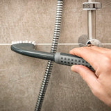 Comfi Grip Tile & Grout Brush - black brush with ergonomic handle and white brussels being used to clean a bathroom