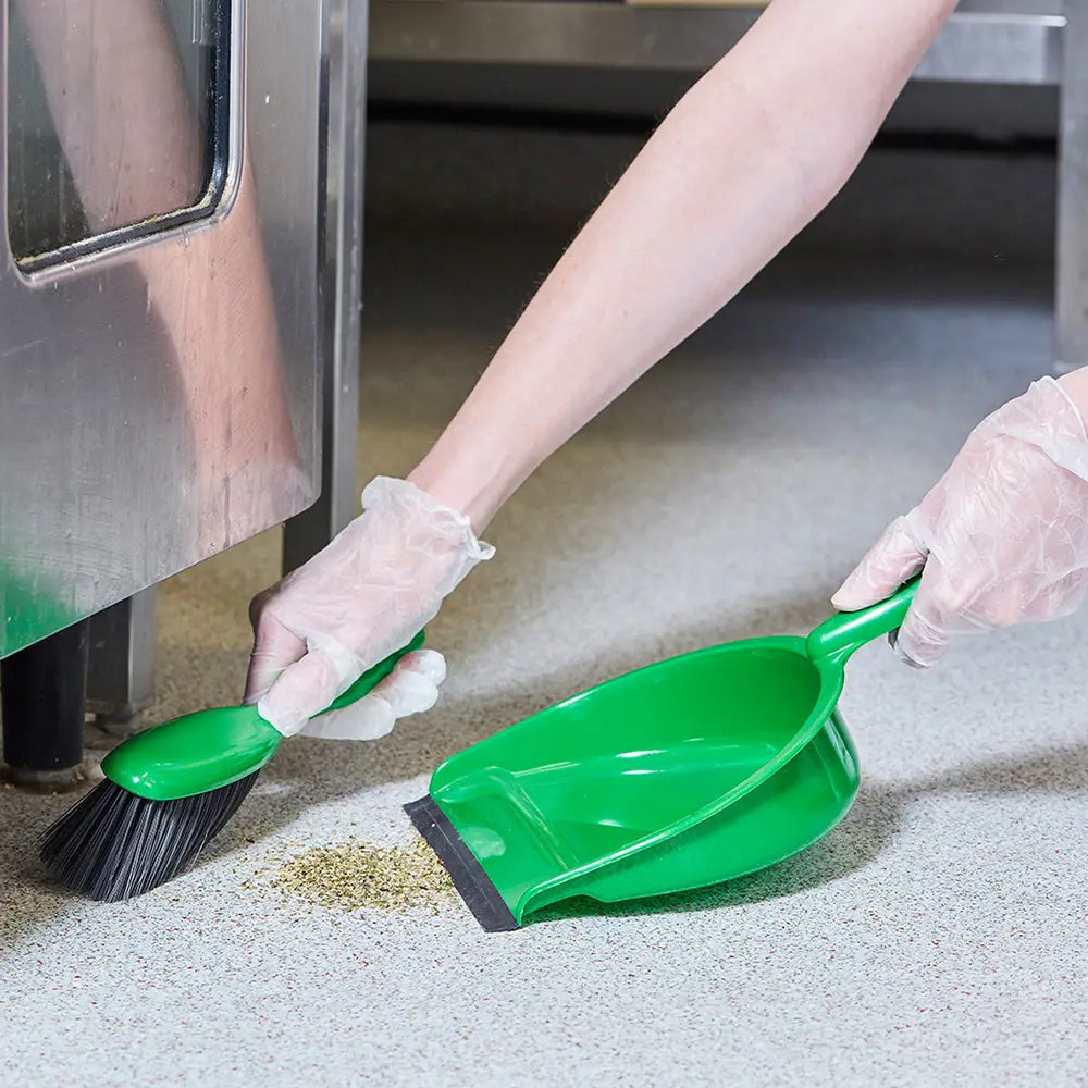 Person cleaning a floor with a green Dustpan & Soft Brush Set