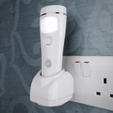 Motion Sensor Safety Light with charging stand plugged in a socket against a gray wall background
