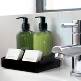 Bathroom sink with Small black Melamine Display Tray with toiletries including bottles and a soap bar 