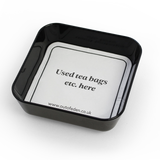 small black tray displaying coaster for used tea bags 
