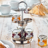 Metal jam stand with jars of jam, orange marmalade, raspberry jam on a wooden table