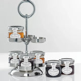 Silver three-tiered stand with jars of jam on a white background