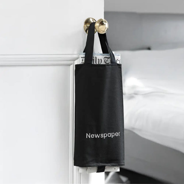 Black newspaper holder with 'Newspaper' embroidered on to the bag