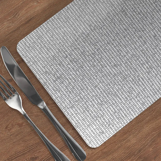 Heat Resistant Melamine Placemat  on a wooden table with silver fork and knife.