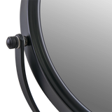 Close-up of a vanity mirror corner with a black knob on a white background