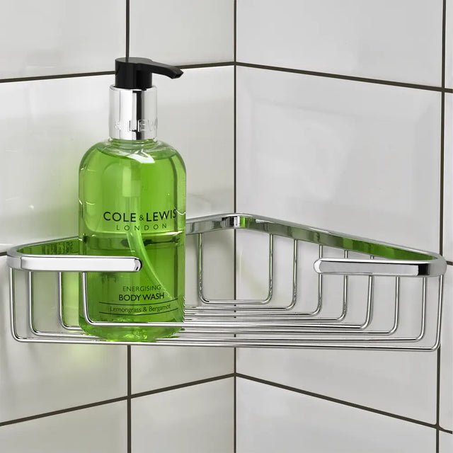 Bottle of Cole & Lewis body wash on a metal corner shower caddy against a tiled wall.
