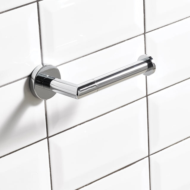 Chrome toilet roll holder pictured on a white tiled wall
